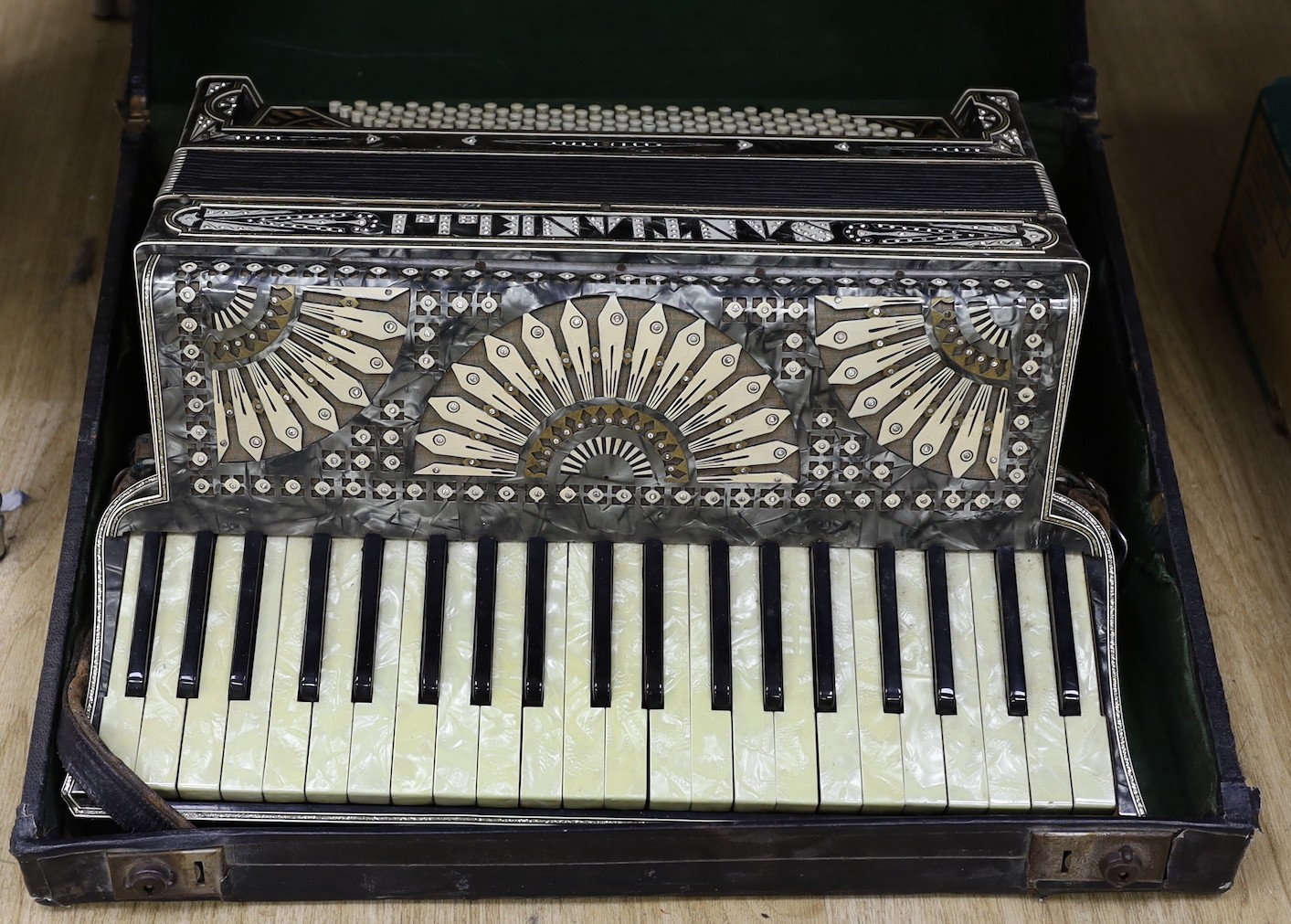 A cased Santiarelli cased accordion, 51 cms wide